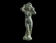 A ROMAN BRONZE MINIATURE STATUETTE OF VENUS ANADYOMENE
Circa 1st-2nd century AD.
Venus is depicted naked, standing in contrapposto on a small plinth, ...