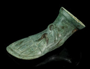 A ROMAN BRONZE LEFT FOOT WITH SANDAL
Circa 1st-3rd century AD.
Hollow cast furniture foot in the form of a human foot with sandal. The sandal with cen...