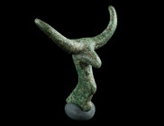AN ARCHAIC BRONZE ATTACHMENT IN THE SHAPE OF A BULL
Circa 9th-7th century BC.
Stylised bull protome with long curved horns.
L 42 mm Ex European privat...