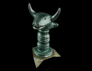 AN IRON AGE/CELTIC BRONZE HEAD OF A BULL
Circa 5th-3rd century BC.
Solid cast protome (head and neck) of a bull with long, curved horns. Set on a shor...