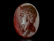 A VERY FINE ROMAN CARNELIAN INTAGLIO WITH A MALE BUST
Circa late 2nd-3rd century AD.
Attractive and very skilfully carved oval intaglio showing a drap...