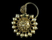 AN ELABORATELY WORKED EASTERN EUROPEAN SILVER GILT EARRING
Circa 17th century AD.
A fine, intricately designed silver gilt earring with filigree and g...