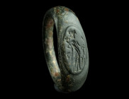 A ROMAN BRONZE RING WITH FORTUNA
Circa 2nd century AD.
Ring with flared shoulders and a slightly raised oval bezel depicting Fortuna with cornucopia a...