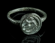 A LATE ROMAN BRONZE RING WITH STYLISED CREATURES
Circa 4th century AD.
Ring with projecting circular bezel depicting some kind of creatures (?).
Ring ...