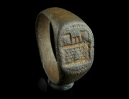 A LATE MEDIEVAL BRONZE HERALDIC RING WITH A CASTLE
Circa 15th century AD.
Ring with oval bezel engraved with a castle gateway.
Ring size 59 (EU) Ex Eu...
