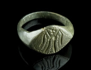 A MEDIEVAL BRONZE RING WITH A HIGHLY STYLISED FIGURE
Circa 14th-15th century AD.
Ring with lozenge-shaped bezel depicting a highly stylised standing f...