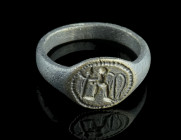 A MEDIEVAL BRONZE RING WITH A STYLISED FIGURE
Circa 14th-15th century AD.
Ring with oval bezel depicting a standing figure with spear and shield, poss...