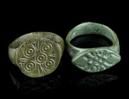 TWO LATE MEDIEVAL/EARLY MODERN BRONZE RINGS
Circa 15th-16th century AD.
Both with an offset bezel decorated with an ornamental design.
Ring size 53 (E...