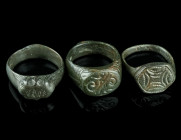 THREE MEDIEVAL/EARLY MODERN BRONZE RINGS
Circa 14th-17th century AD.
Three rings of different shape and design with incised decoration.
Ring size 56-5...