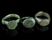 THREE MEDIEVAL/EARLY MODERN BRONZE RINGS
Circa 14th-17th century AD.
Three rings of different shape and design with incised decoration.
Ring size 51-5...