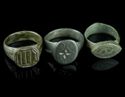 THREE MEDIEVAL/EARLY MODERN BRONZE RINGS
Circa 14th-17th century AD.
Three rings of different shape and design with incised decoration.
Ring size 53-5...
