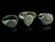 THREE LATE MEDIEVAL/EARLY MODERN BRONZE RINGS
Circa 15th-17th century AD.
Three rings of different shape and design; two with incised decoration, the ...