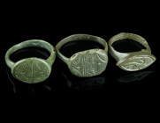 THREE MEDIEVAL/EARLY MODERN BRONZE RINGS
Circa 14th-17th century AD.
Three rings of different shape and design with incised decoration.
Ring size 51-5...