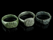 THREE MEDIEVAL/EARLY MODERN BRONZE RINGS
Circa 14th-17th century AD.
Three rings of different shape and design with incised decoration.
Ring size 54-5...