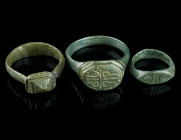 THREE MEDIEVAL/EARLY MODERN BRONZE RINGS
Circa 14th-17th century AD.
Three rings of different shape and design with incised decoration.
Ring size 40-6...
