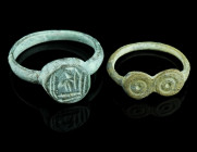A LATE ROMAN AND A SMALL BYZANTINE BRONZE RING
Circa 4th century AD, and 5th-7th century AD.
A late Roman ring with projecting circular bezel depictin...