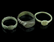 TWO BYZANTINE AND A MEDIEVAL BRONZE RING
Circa 5th-7th century, and 14th-15th century AD.
Two Byzantine rings with oval bezel depicting a cross and a ...
