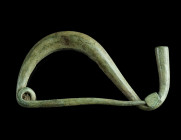 AN IRON AGE/EASTERN CELTIC BRONZE BOW FIBULA
Circa 4th-3rd century BC.
La Tène Type/Thracian Type fibula. Made of one piece with spring and pin; the f...