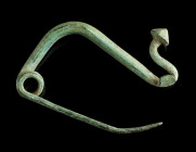 AN IRON AGE/EASTERN CELTIC BRONZE BOW FIBULA
Circa 4th-3rd century BC.
La Tène Type/Thracian Type fibula. Made of one piece with spring and pin; the f...