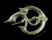 A ROMAN BRONZE OPENWORK TRUMPET BROOCH
Circa 2nd-3rd century AD.
Fine plate brooch with a complex Celtic trumpet-style design. With hinged pin; part o...