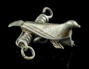 A ROMAN SILVER BIRD BROOCH
Circa 2nd-3rd century AD.
Modelled in the shape of a bird with folded wings. The body is decorated with two grooves along t...