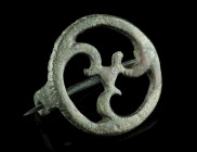 A ROMAN BRONZE OPENWORK DISK BROOCH
Circa 2nd-3rd century AD.
With an openwork triskeles (or triple spiral) motif. Hinged pin.
Diameter 30 mm Ex Europ...