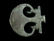 A ROMAN TINNED BRONZE OPENWORK PELTA BROOCH
Circa 2nd-3rd century AD.
Plate brooch with an openwork pelta design and a notched edge. Remains of tinnin...