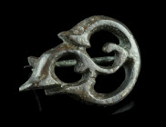 A ROMAN BRONZE OPENWORK TRUMPET BROOCH
Circa 2nd-3rd century AD.
Plate brooch with a complex Celtic trumpet-style design. Hinge and pin repaired.
L 35...