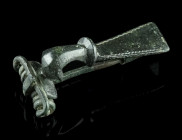 A ROMAN BRONZE STRONGLY PROFILED BROOCH
Circa 2nd century AD.
A so-called 'Kräftig Profilierte Fibel' with trapezoid foot decorated with a zigzag patt...