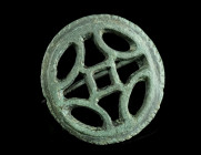 A ROMAN BRONZE OPENWORK DISK BROOCH
Circa 2nd-3rd century AD.
With an openwork design and a notched edge. Hinged, pin ancient but probably not belongi...