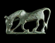 A ROMAN BRONZE HORSE BROOCH 
Circa 2nd-3rd century AD.
Plate brooch in the form of a grazing horse to left, set on a horizontal baseline. Worked in re...