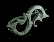 A ROMAN TINNED BRONZE S-SHAPED BROOCH
Circa 2nd-3rd century AD.
S-shaped openwork plate brooch with expanded ends. A stylised ivy leaf to each side. H...