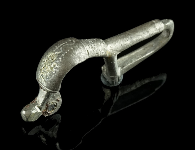 A BYZANTINE SILVER BROOCH WITH BENT FOOT
Circa 6th-7th century AD.
Cast bow broo...