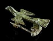 A LATE ANTIQUE BRONZE BIRD BROOCH
Circa 5th-6th century AD.
Brooch in the form of a bird with swept back wings and fantail. Body and head are decorate...