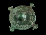 A MIGRATION PERIOD BRONZE DISK BROOCH
Circa 5th-6th century AD.
Disk brooch with a central boss and four peripheral bird head shaped lugs. The disk is...
