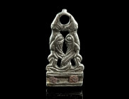 A MEDIEVAL SILVER STRAP-END WITH MYTHICAL CREATURES
Circa 9th-11th century AD.
Openwork interlaced strap end with two intertwined winged beasts. At th...