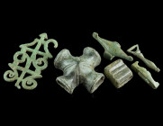 A GROUP OF SIX ROMAN BRONZE DECORATIVE OBJECTS
Circa 2nd-3rd century AD.
Four belt/strap decorations of different design, a small pendant, and a knife...