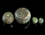 A GROUP OF FOUR BYZANTINE BRONZE SPHERICAL WEIGHTS
Circa 5th-7th century AD.
Commercial weights. The two small weights inscribed Γ, the two larger wei...