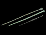 A GROUP OF THREE ROMAN BRONZE LIGULAE
Circa 1st-4th century AD.
Pin-like medical instruments or cosmetic spoons with a small scoop at one end (ligula)...