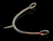 A CELTIC IRON SPUR FROM THE MIDDLE/LATE LA TENE PERIOD
Circa 3rd-1st century BC.
Prick spur with central goad and side arms with large loop terminals....