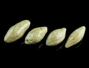A GROUP OF FOUR GREEK/ROMAN LEAD SLING-SHOTS 
Circa 3rd century BC - 1st century AD.
Almond shaped sling bullets of different size. 
L 28-34 mm Ex Eur...