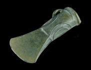 A EUROPEAN LATE BRONZE AGE SOCKETED AXE HEAD
Circa 1000-800 BC.
Socketed and looped bronze axe head with banded collar and ribbed decoration; gently f...