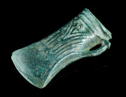 A EUROPEAN LATE BRONZE AGE SOCKETED AXE HEAD
Circa 1000-800 BC.
Socketed and looped bronze axe head with triple-banded collar and elaborate ribbed dec...