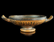 AN ATTIC BLACK FIGURE FLORAL BAND CUP (KYLIX)
Circa 500-450 BC.
Shallow bowl with two looped handles, decorated with a lotus and palmette band; a rese...