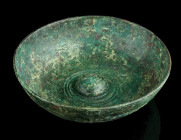 A GREEK BRONZE PHIALE WITH AN OMPHALOS
Circa 5th-4th century BC.
Cast bronze phiale (libation bowl) with a hollow, rounded, raised boss in the centre ...