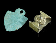 A SILVER-GILT STRAP DECORATION AND A SPADE-SHAPED PENDANT
Circa 14th-16th century AD, and 1st-3rd century AD.
A medieval or early modern strap decorat...