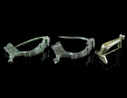A GROUP OF THREE ROMAN BRONZE BROOCHES
Circa 2nd-3rd century AD.
Two bow brooches, and a knee brooch. All with hinged pin.
L 26-42 mm Ex European priv...