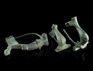A GROUP OF THREE ROMAN BRONZE BROOCHES
Circa 2nd-3rd century AD.
Two knee brooches, and a bow brooch. All with hinged pin. Two pins probably restored....