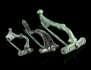 A GROUP OF THREE ROMAN BRONZE BROOCHES
Circa 1st-3rd century AD.
Two strongly profiled brooches with spring and pin, and a brooch with divided bow and...