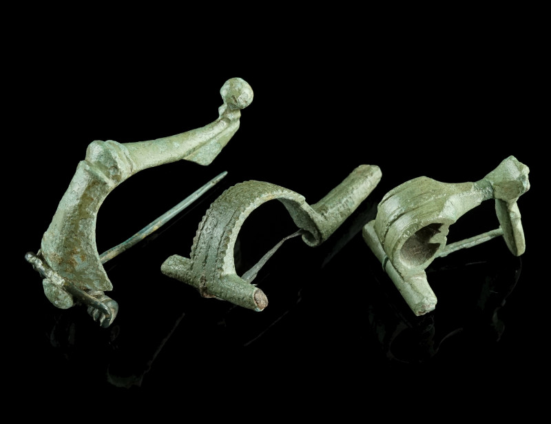 A GROUP OF THREE ROMAN BRONZE BROOCHES
Circa 2nd-3rd century AD.
A strongly prof...